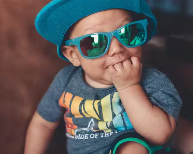 toddler with fingers in his mouth